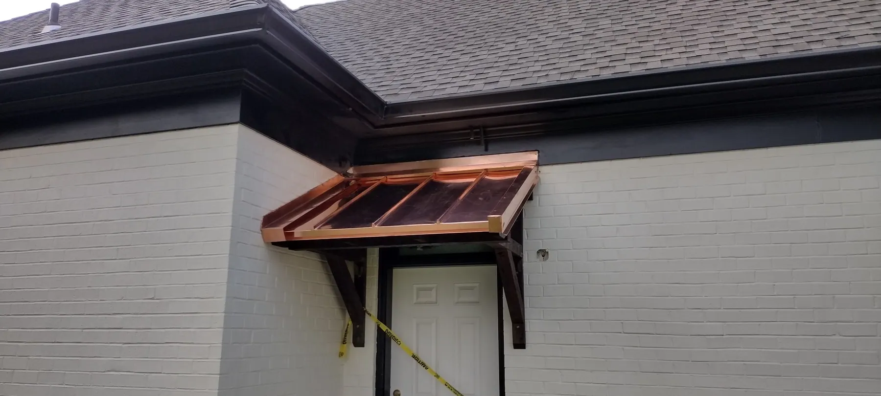Custom copper roof over a residential entry overhang