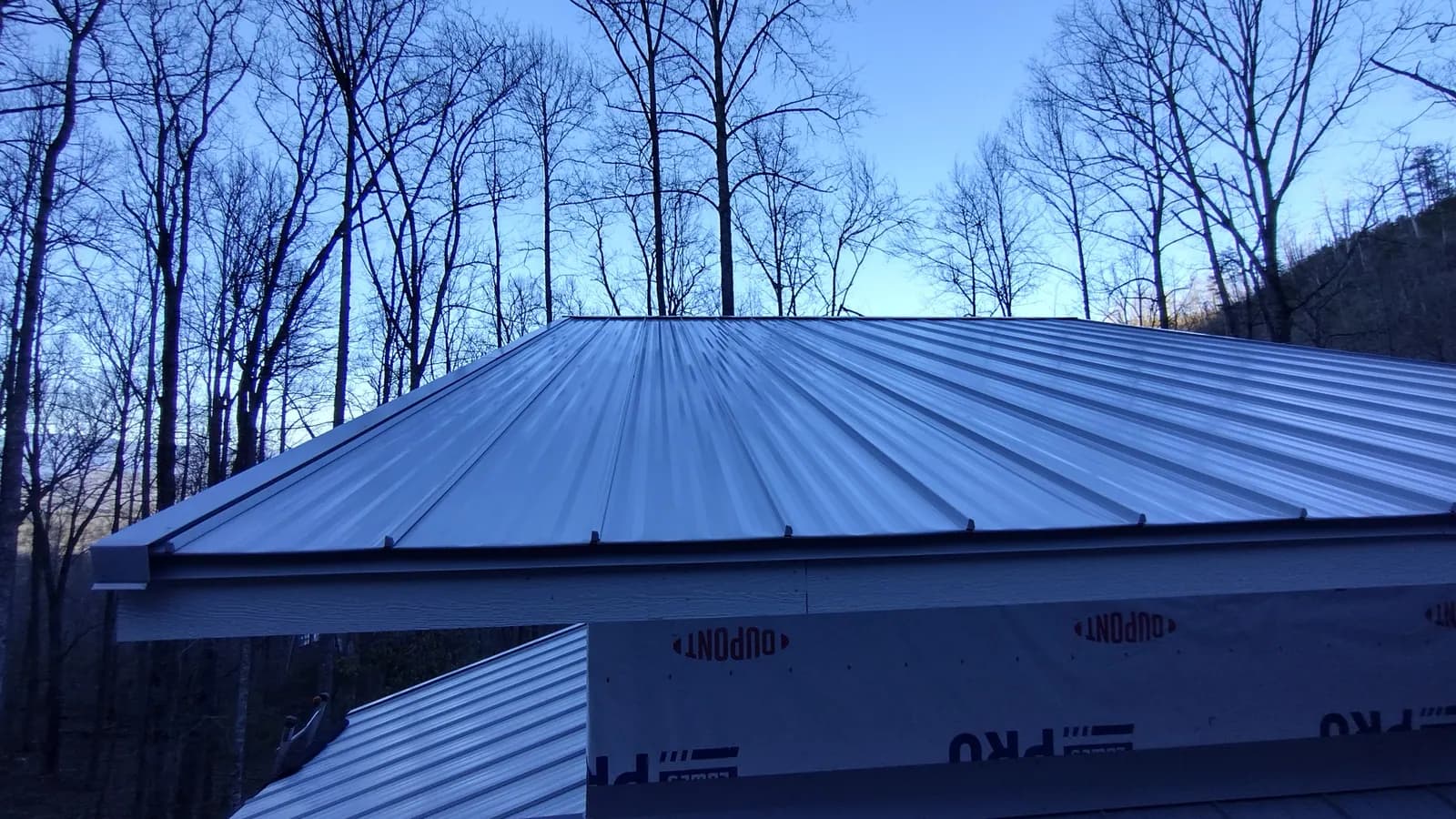 Roof deck covered in synthetic underlayment before metal panel installation
