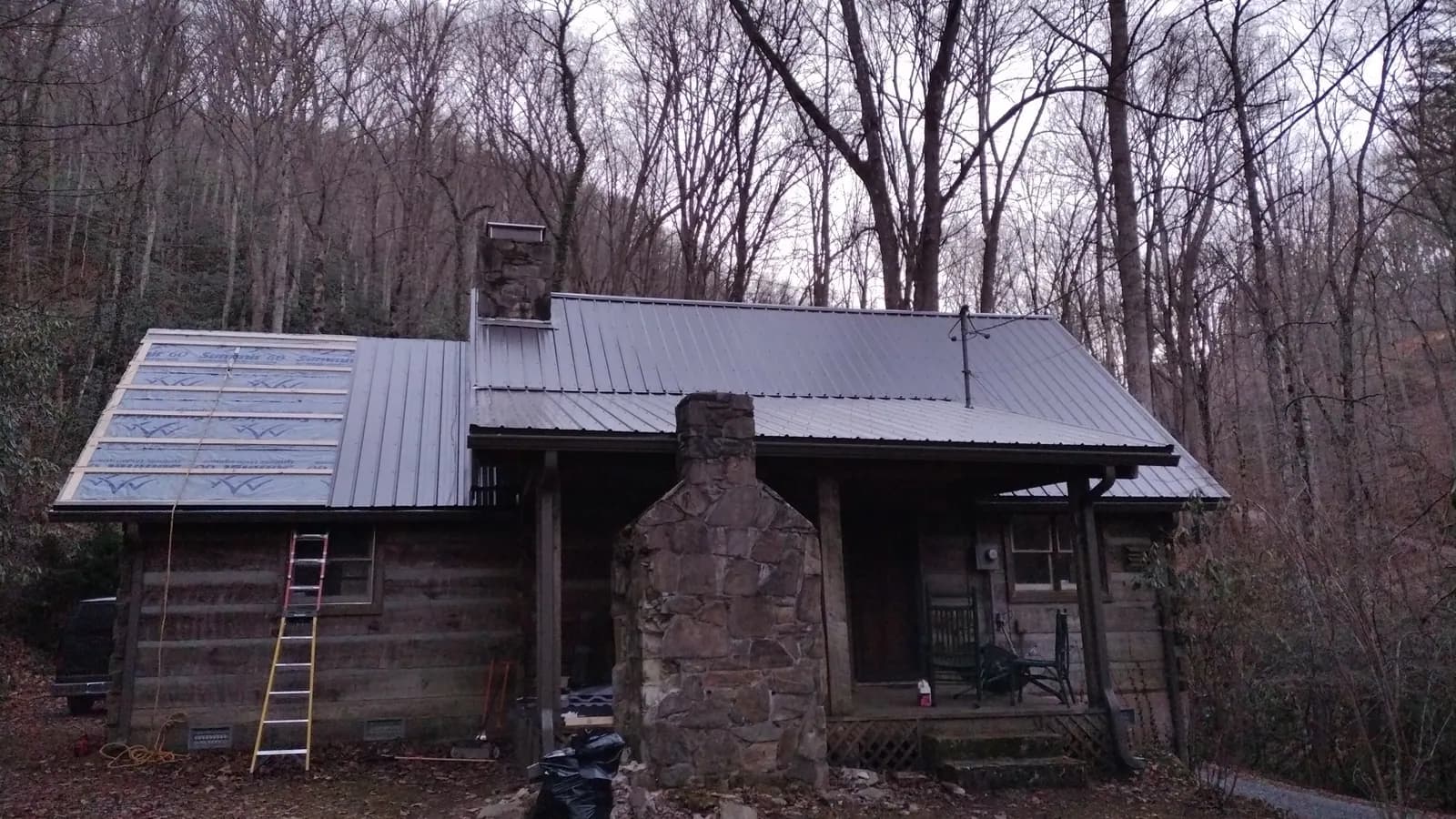 Mountain cabin with a newly installed dark metal roof