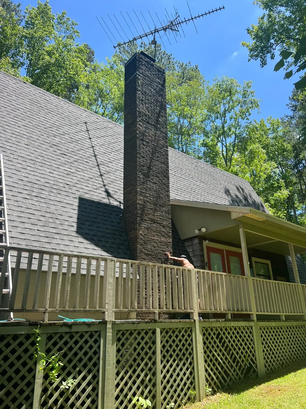 Crew working on an extremely steep pitched shingle roof